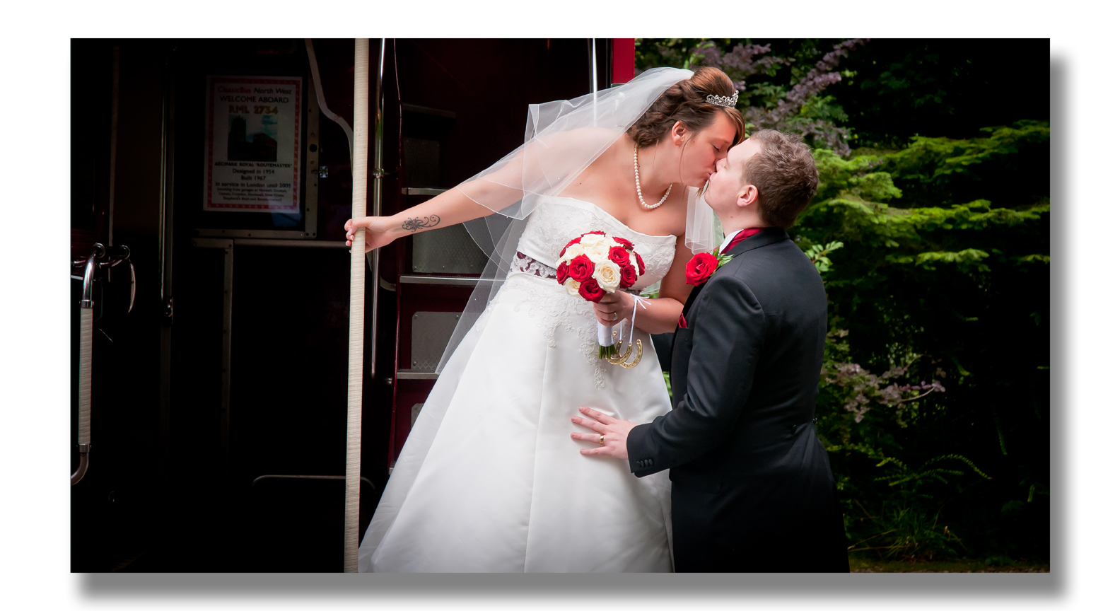 bride and groom kissing on bus